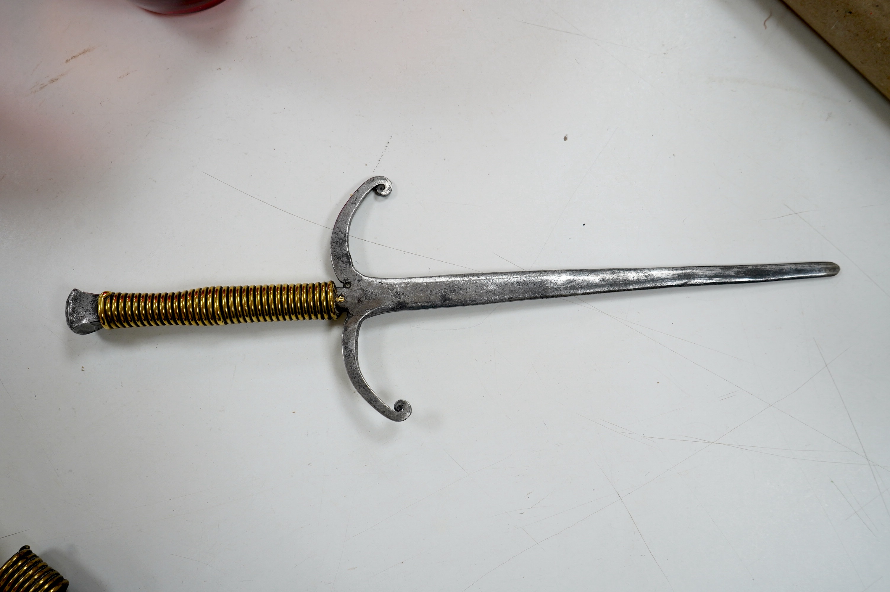 An ornamental iron dagger, in sheath, 42cm long including sheath. Condition - fair